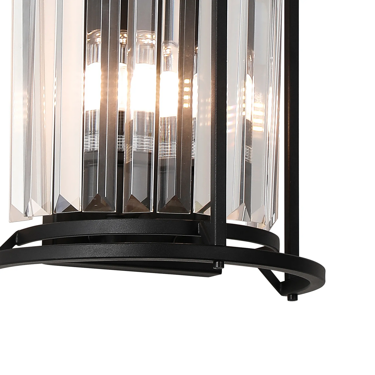 Close up of a black metal and clear crystal chandelier with three light bulbs glowing
