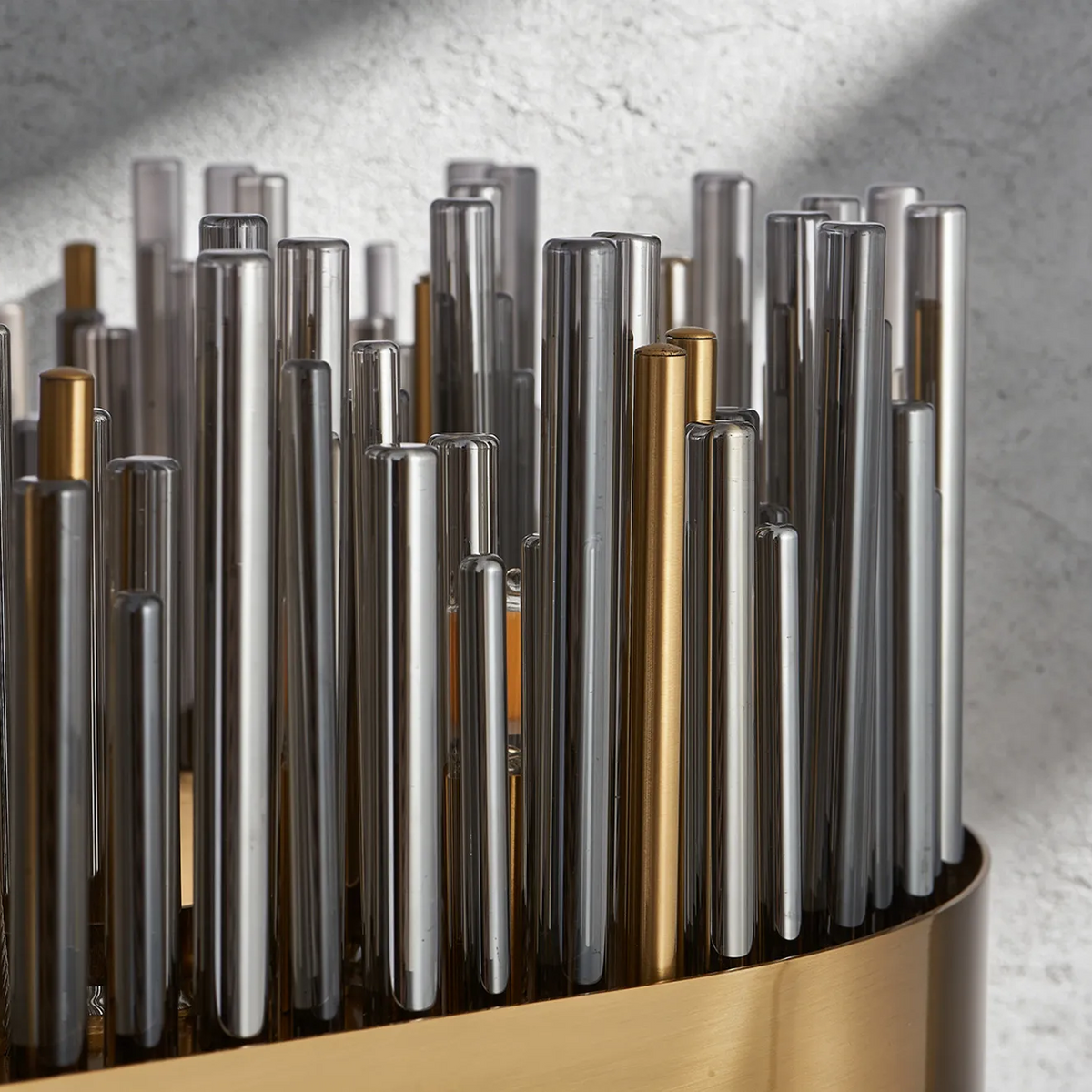 Close up of a decorative object with many vertical metal rods in silver and gold