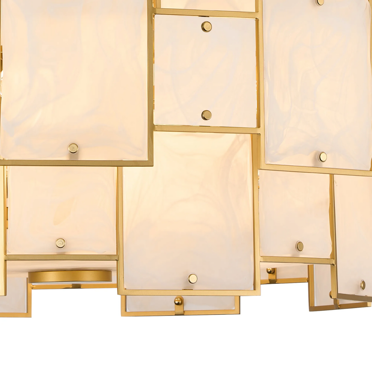 Close-up of a gold chandelier with rectangular white glass panels