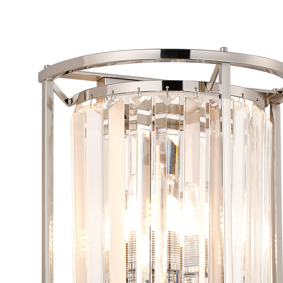 Close up of a polished chrome and crystal wall sconce