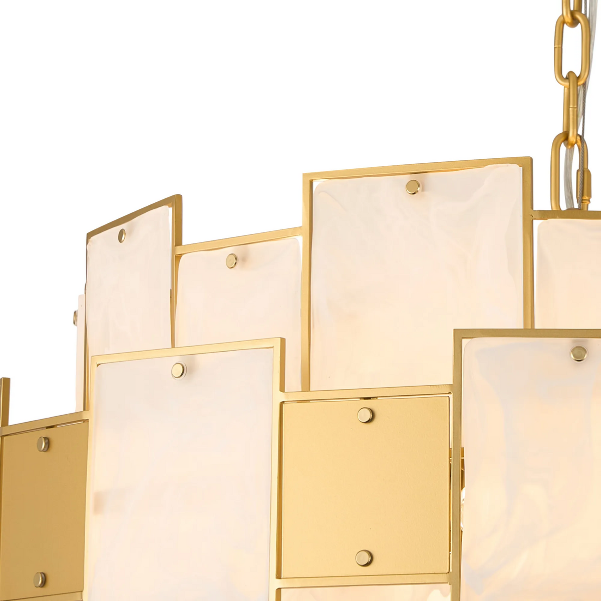 Close-up of a gold chandelier with rectangular frosted glass panels