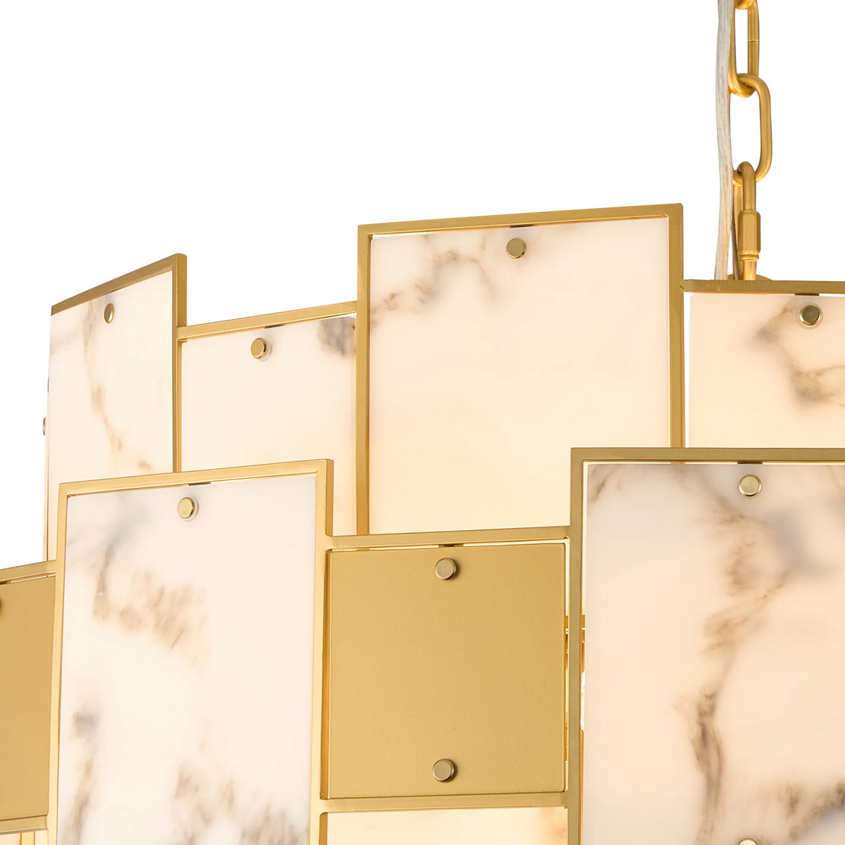 Close up of a gold chandelier with white marble panels