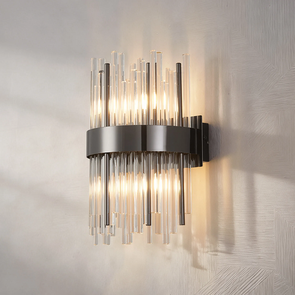 Black and clear glass tube wall sconce with warm light