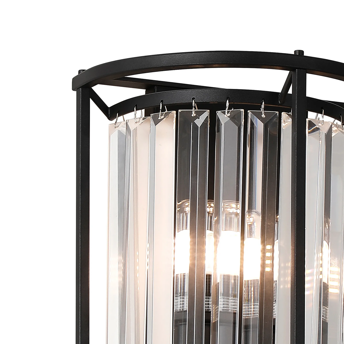 Close up of a black metal frame chandelier with clear rectangular crystal accents and illuminated bulbs