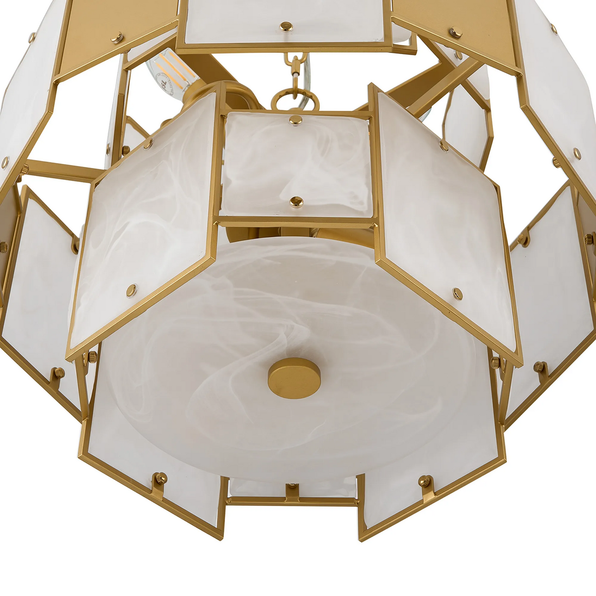 Close-up of a gold chandelier with white frosted glass panels