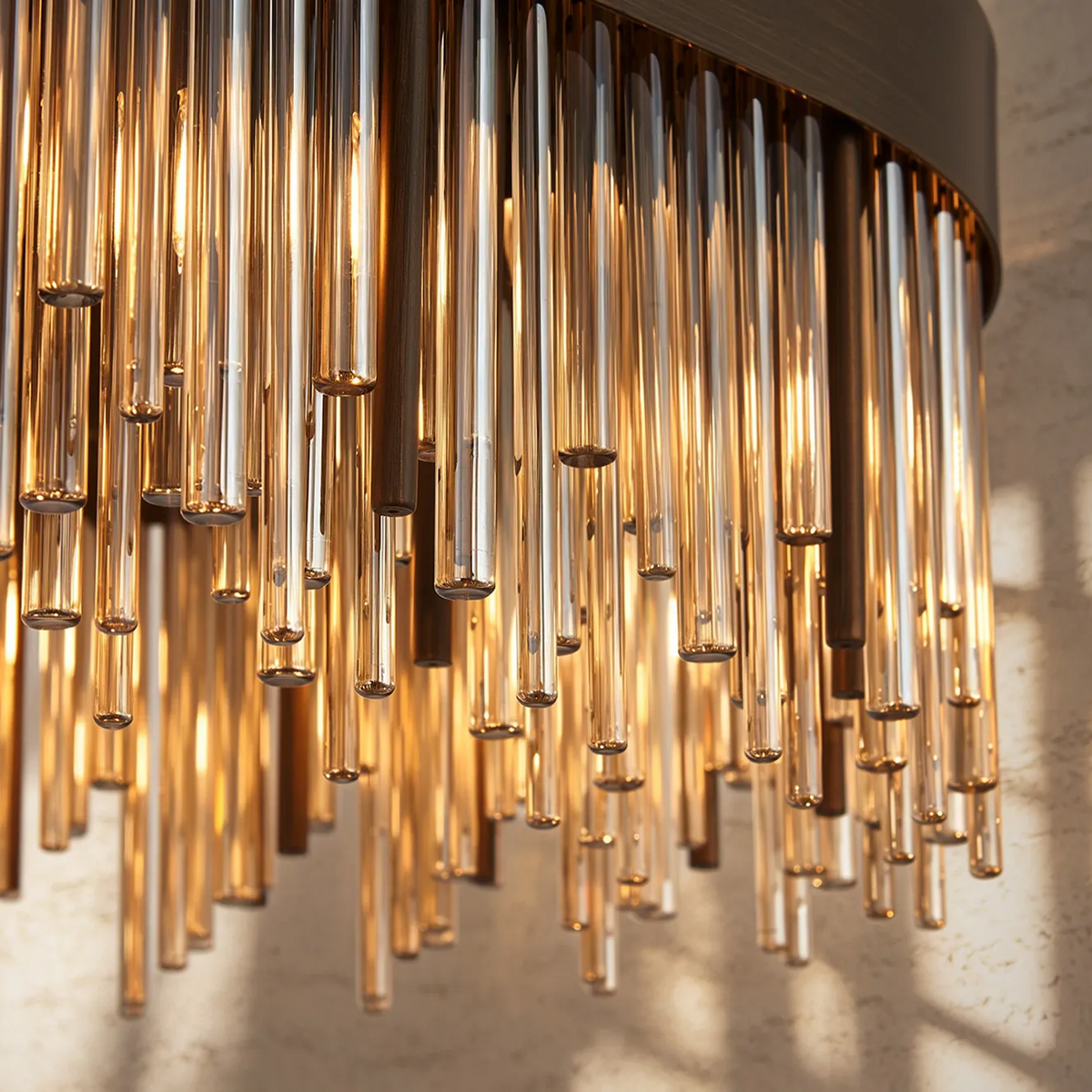 Close up of a chandelier with many amber glass rods hanging down