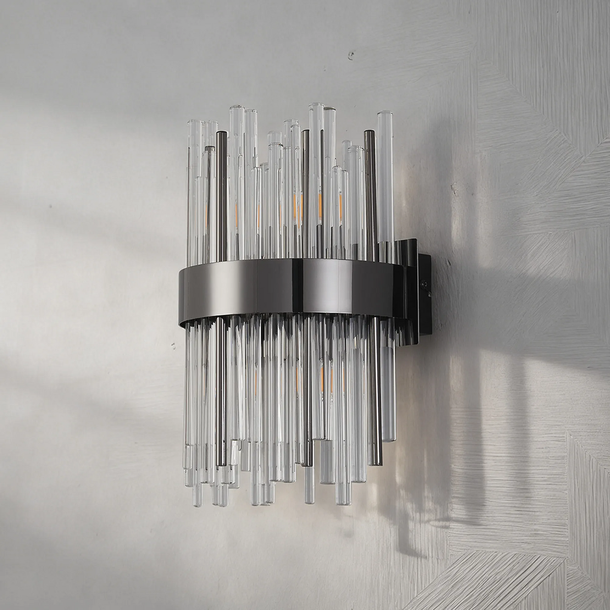 Black wall sconce with clear and dark glass rods