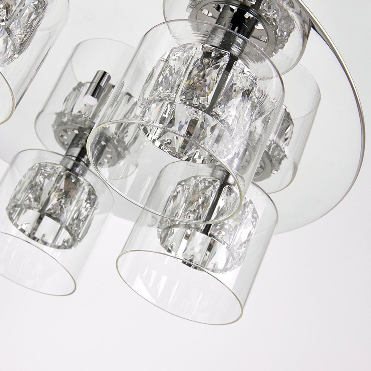 An angled close-up of the chrome and crystal ceiling light with clear glass shades.
