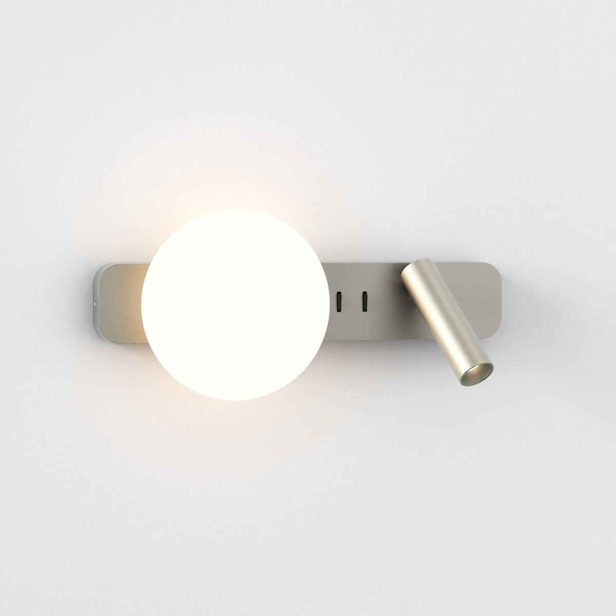 Brushed metal wall light with a round illuminated bulb and an adjustable cylindrical spotlight