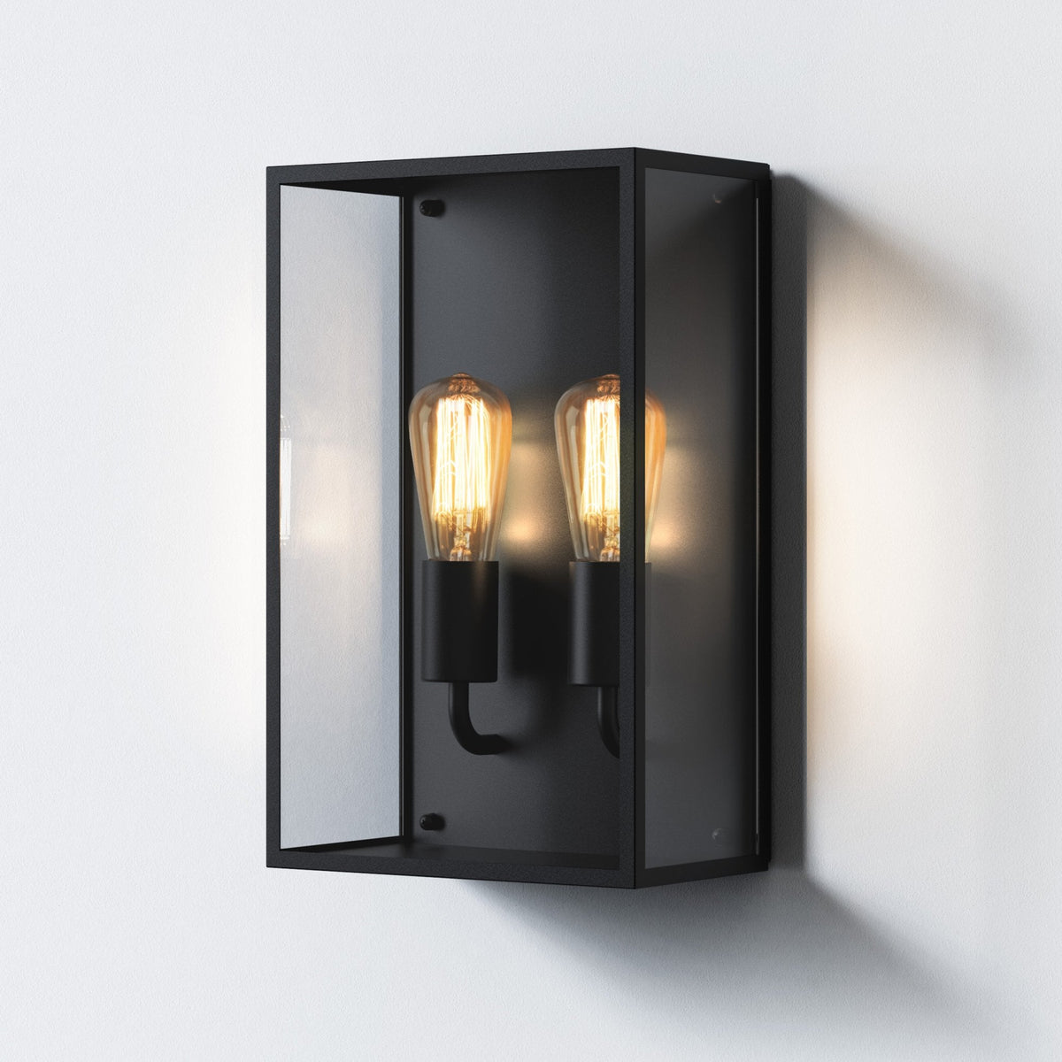 Black rectangular wall sconce with two exposed Edison bulbs