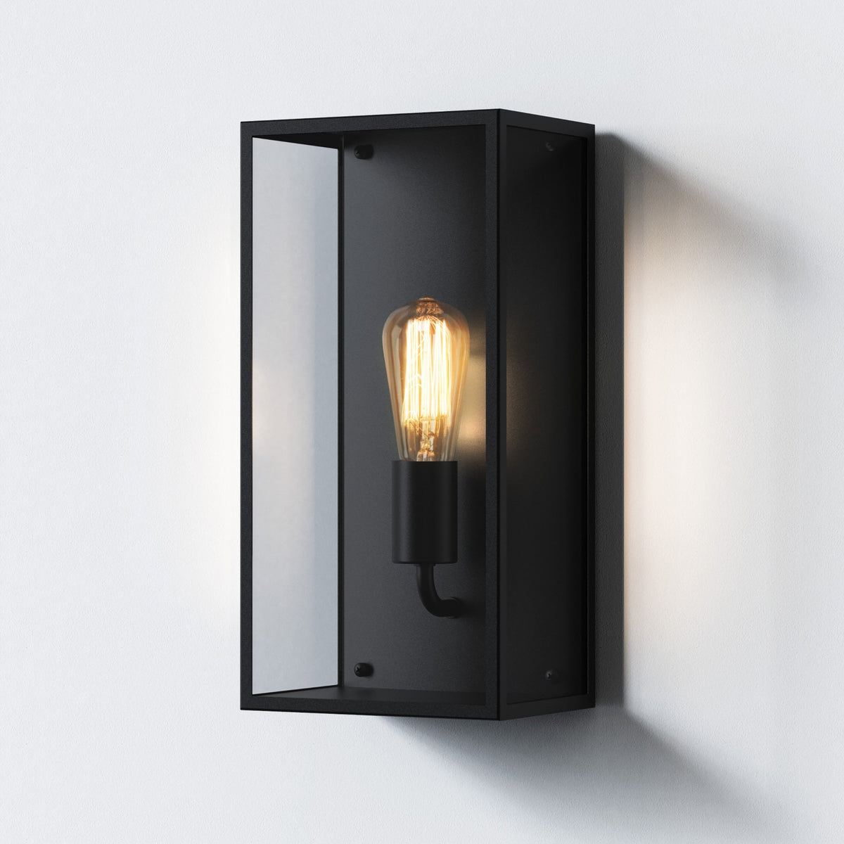 Black rectangular outdoor wall light with clear glass panels and an exposed Edison bulb