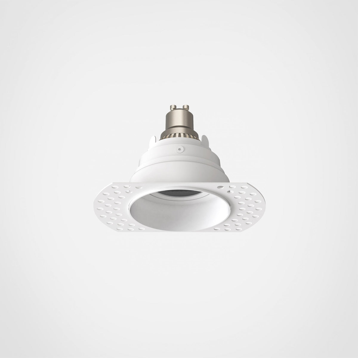 White recessed lighting fixture with a circular trim and a silver-colored top on a white background