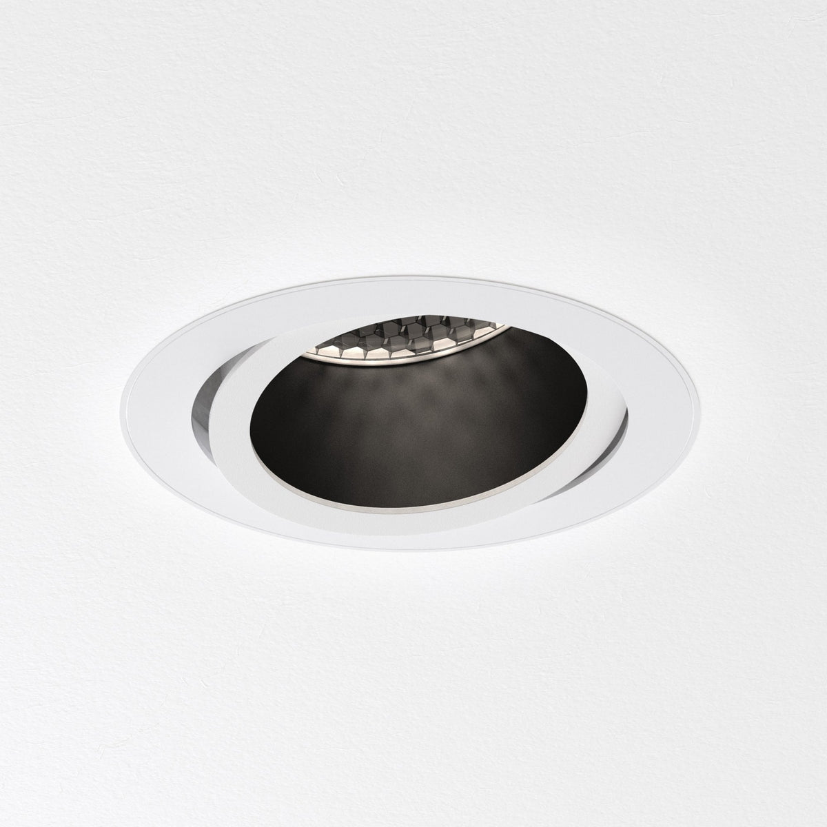 White recessed ceiling light with a black interior and a hexagonal patterned reflector