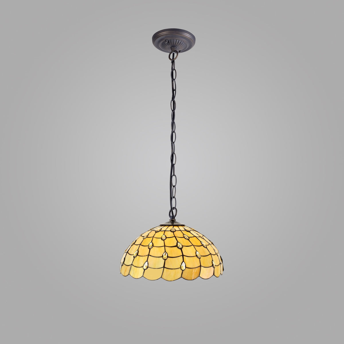 A yellow pendant light with a stained glass shade hangs from a chain on a gray background.