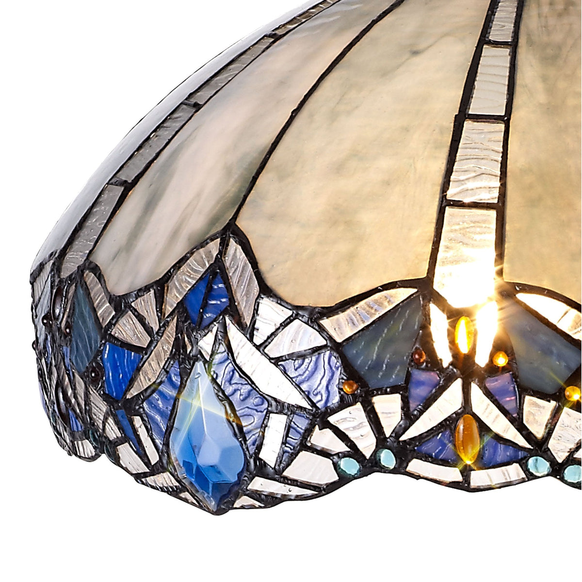 A close-up of the intricate blue and white stained glass pattern on the lamp shade.