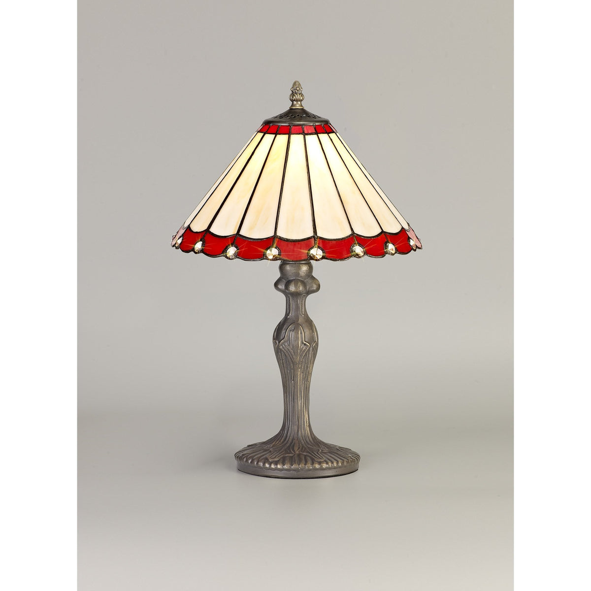 A decorative red and cream Tiffany-style table lamp with an ornate bronze base on a grey background.