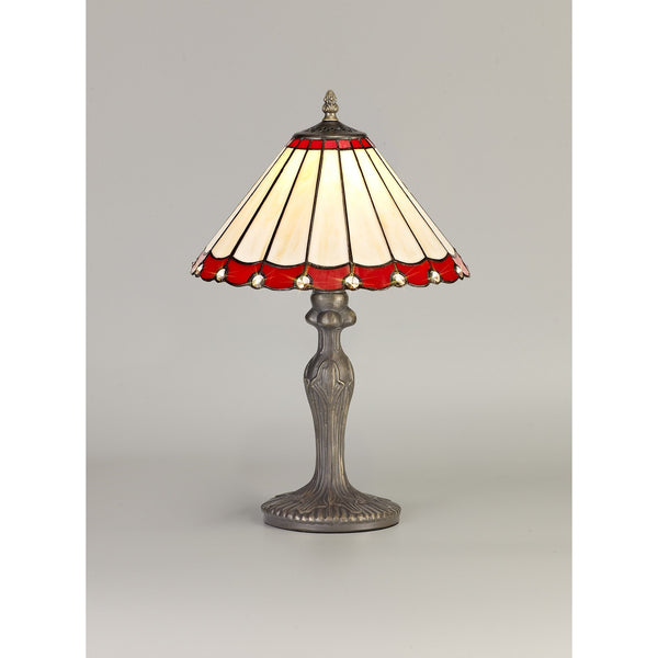 A decorative red and cream Tiffany-style table lamp with an ornate bronze base on a grey background.