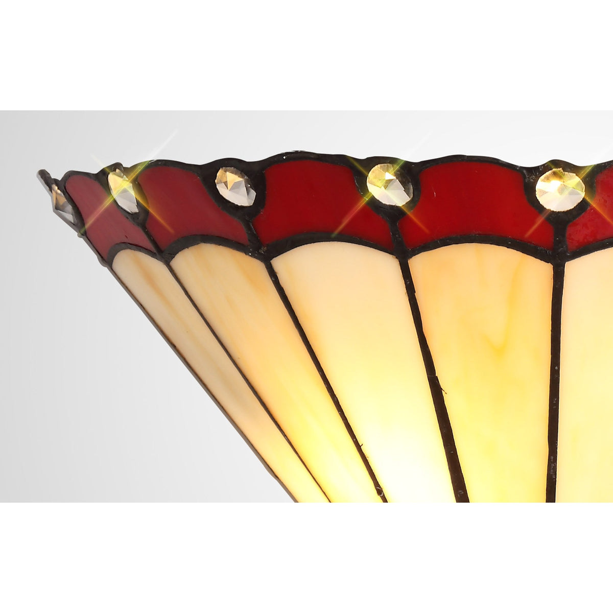 A close-up of the red and white stained glass wall light from the side.