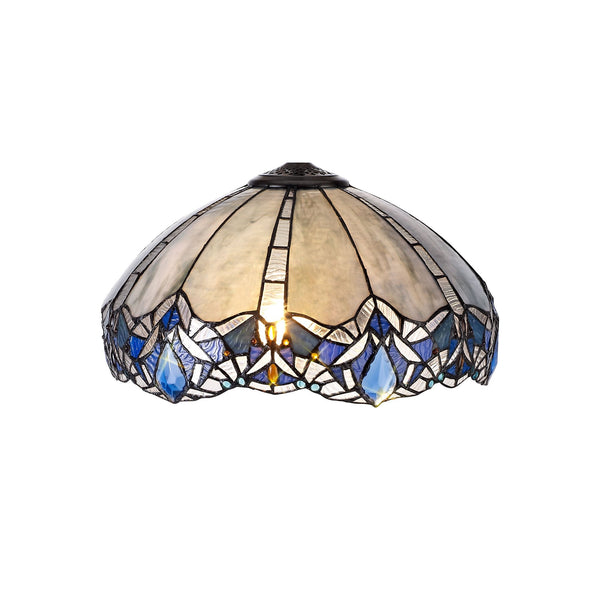 A Tiffany-style lamp shade with a pattern of white and blue stained glass pieces.