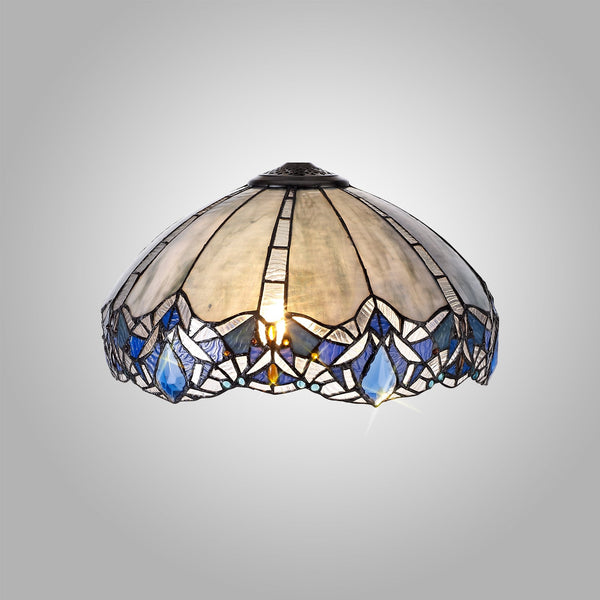 A Tiffany-style lamp shade with a pattern of white and blue stained glass pieces.