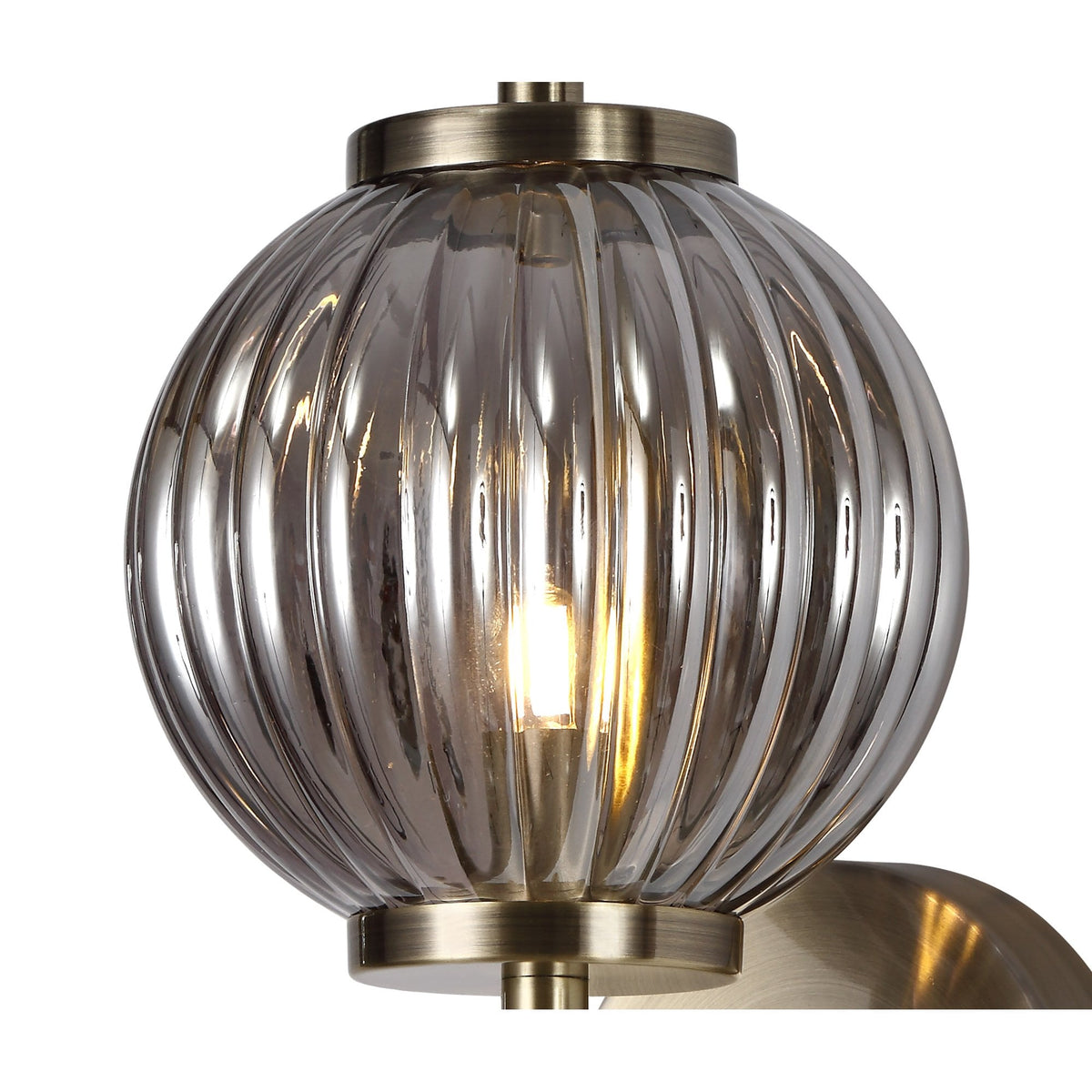 Detailed close-up of the ribbed smoked glass orb with a lit bulb inside.
