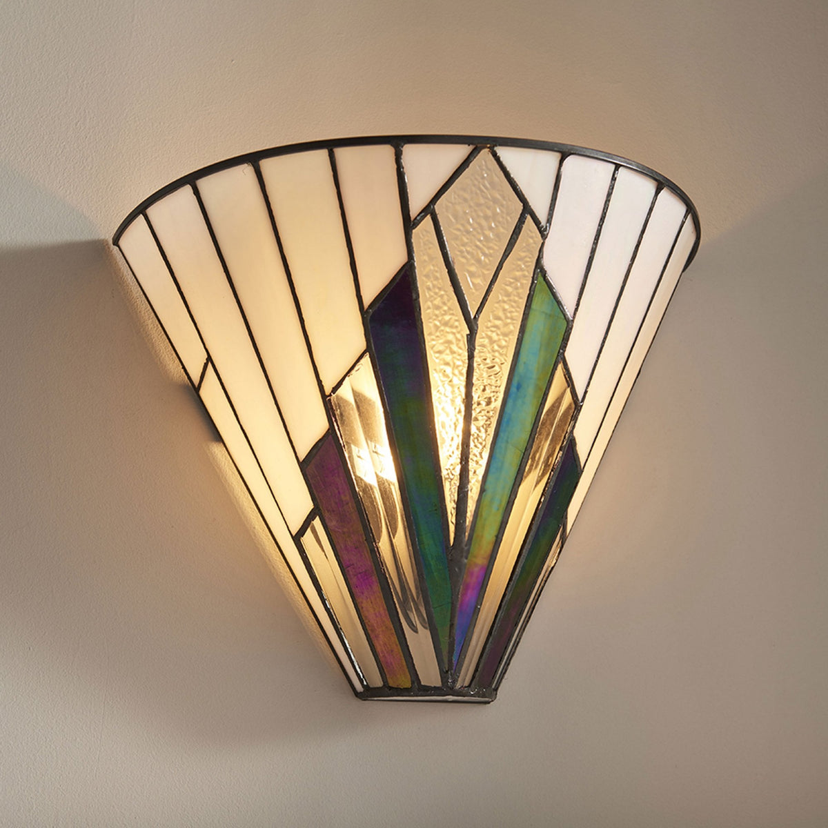 Art Deco style wall light with white and iridescent glass panels, emitting a warm glow.