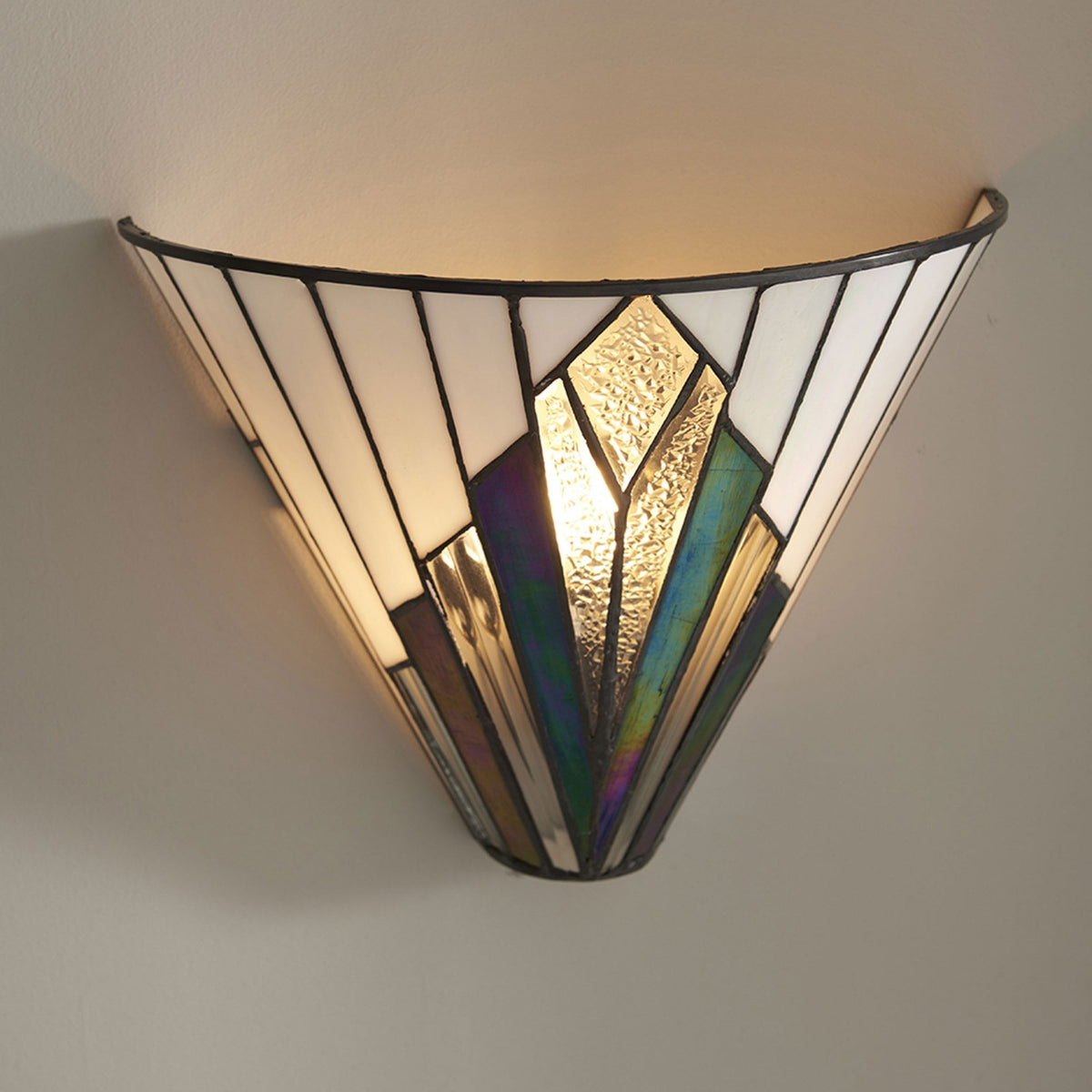 Art Deco wall light in a white and iridescent glass design, casting light upwards.