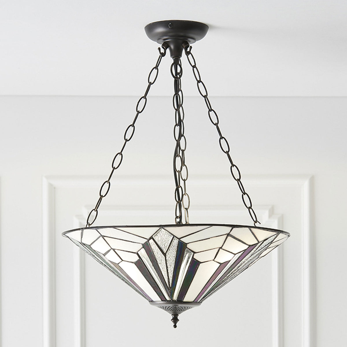 A decorative ceiling light fitting with a white and purple patterned shade and metal chains.