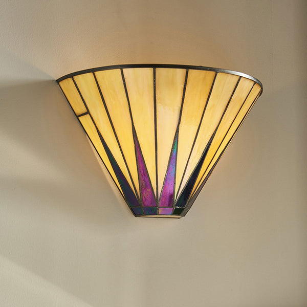 A close-up of a wall light with a yellowish stained glass shade and purple accents.