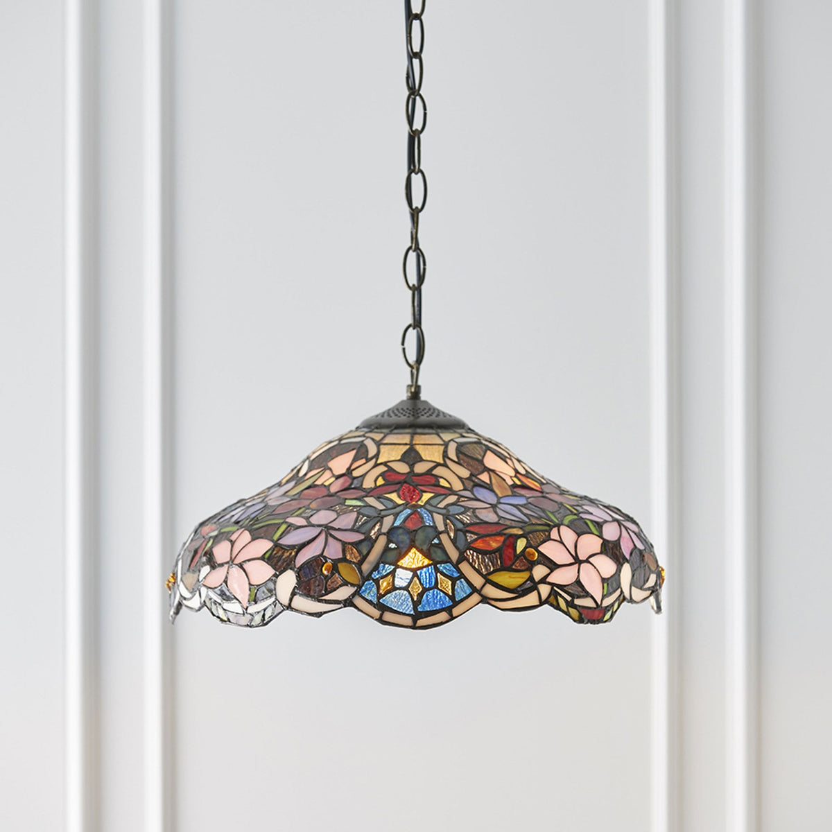 A close-up view of the Tiffany-style pendant light, showcasing its vibrant colours and floral pattern.