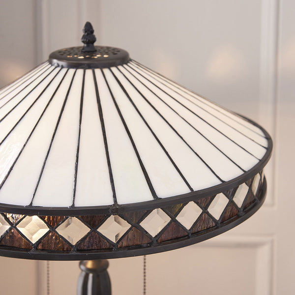 Close-up of the lamp's shade, showing its white and dark geometric pattern.