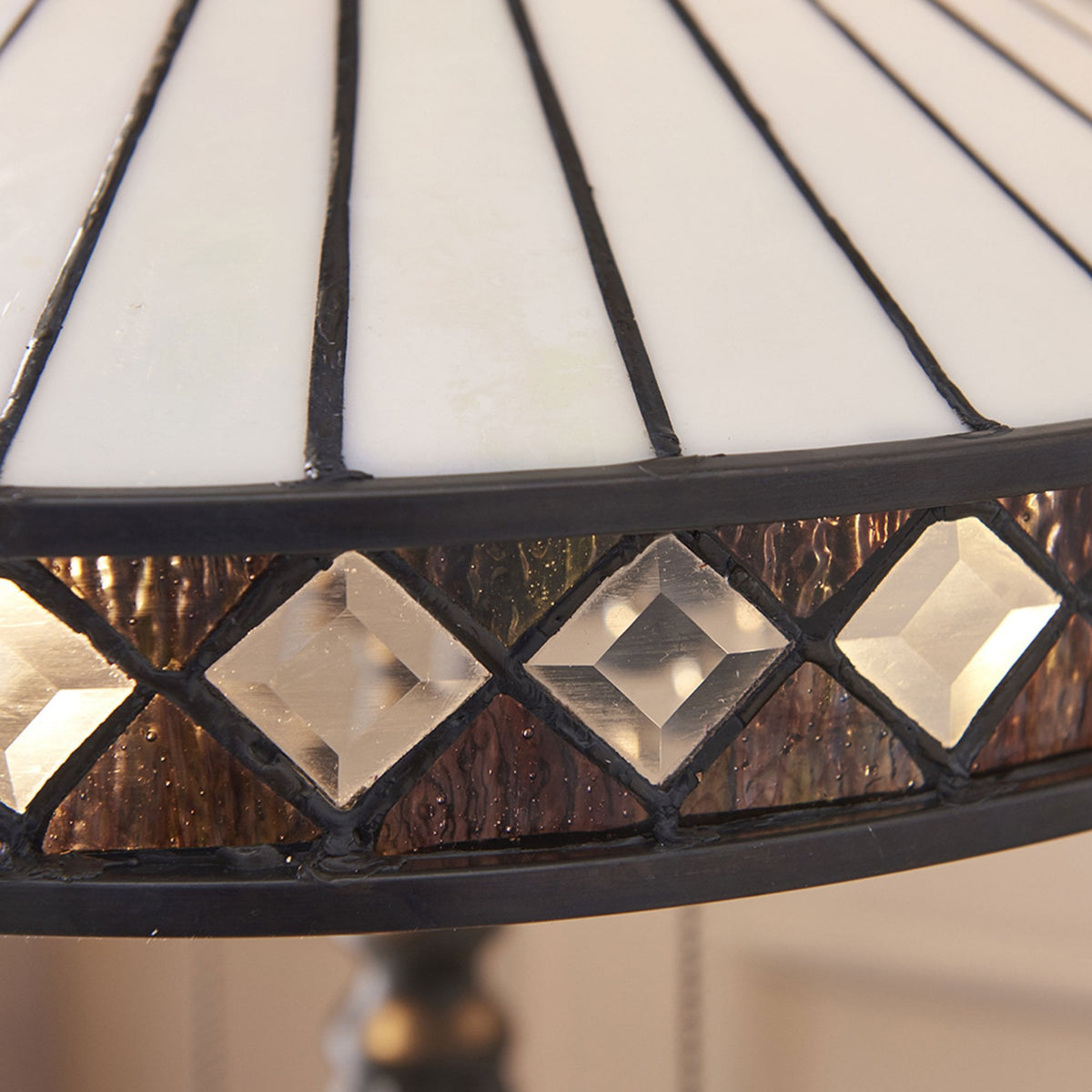 A close-up of the lamp's shade, highlighting the intricate diamond and stripe pattern.