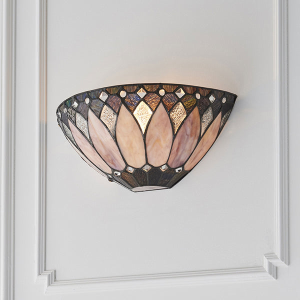 A close-up of the Tiffany lotus flower pink and purple glass wall light, illuminated.
