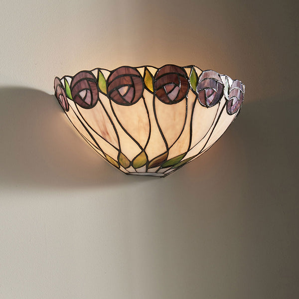 A Tiffany wall light with purple stained glass flowers mounted on a wall.