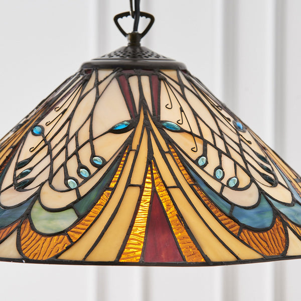 A close-up of the multicoloured glass shade of a Tiffany-style pendant light, showing intricate details.