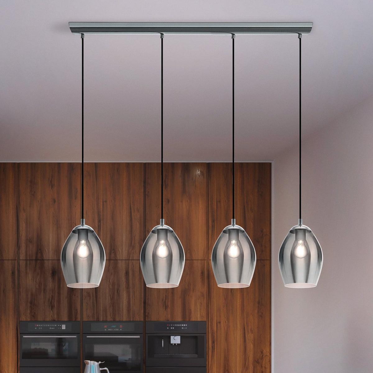 Four pendant lights with chrome bases and clear glass shades hang from a rectangular ceiling fixture.