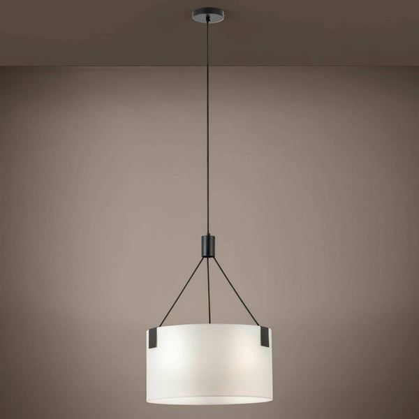 A black pendant light with a wide, white, cylindrical shade suspended from the ceiling.