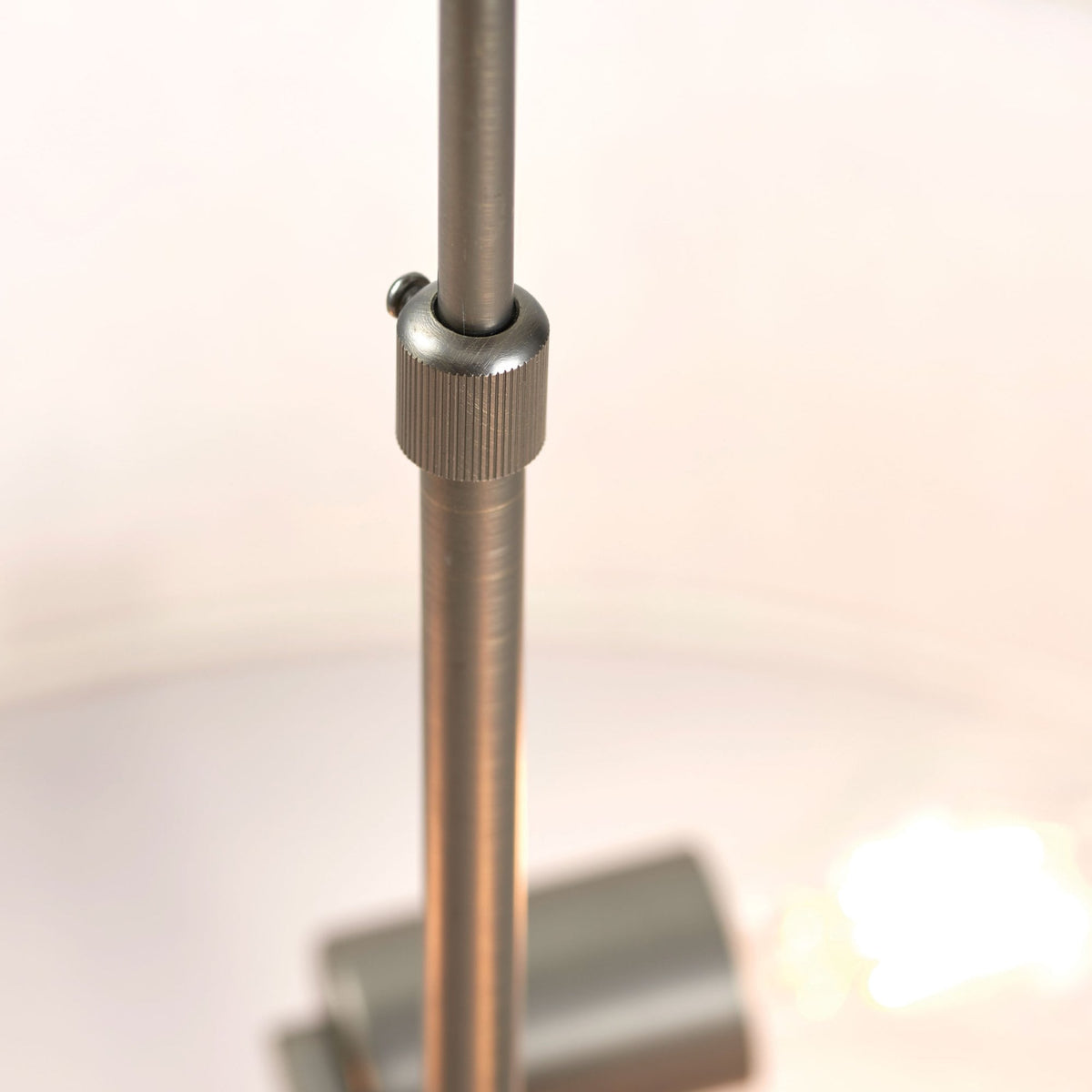 Close-up of the adjustable rod connecting the pendant light to the ceiling mount.