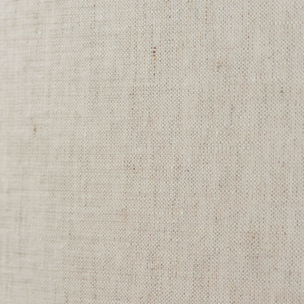 Close-up of the textured, light-colored fabric of the pendant light shade.