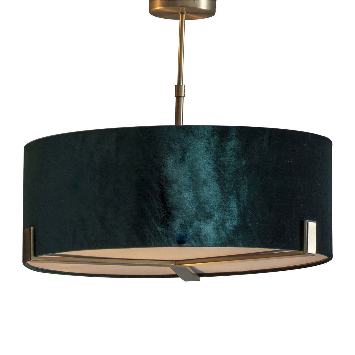 A dark green velvet drum pendant light with gold accents on a white background.