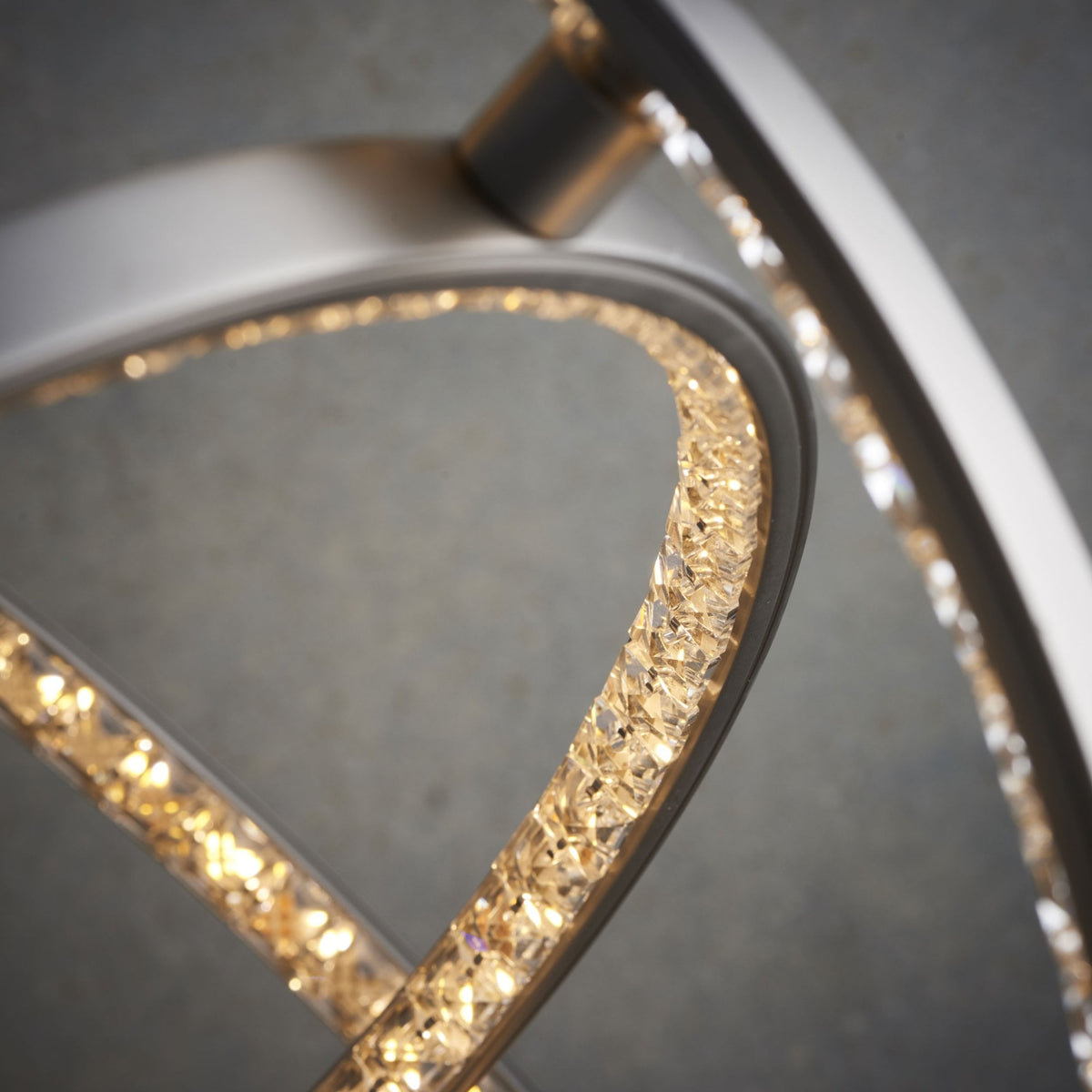 A close-up view of the illuminated, textured inner surface of a modern pendant light.