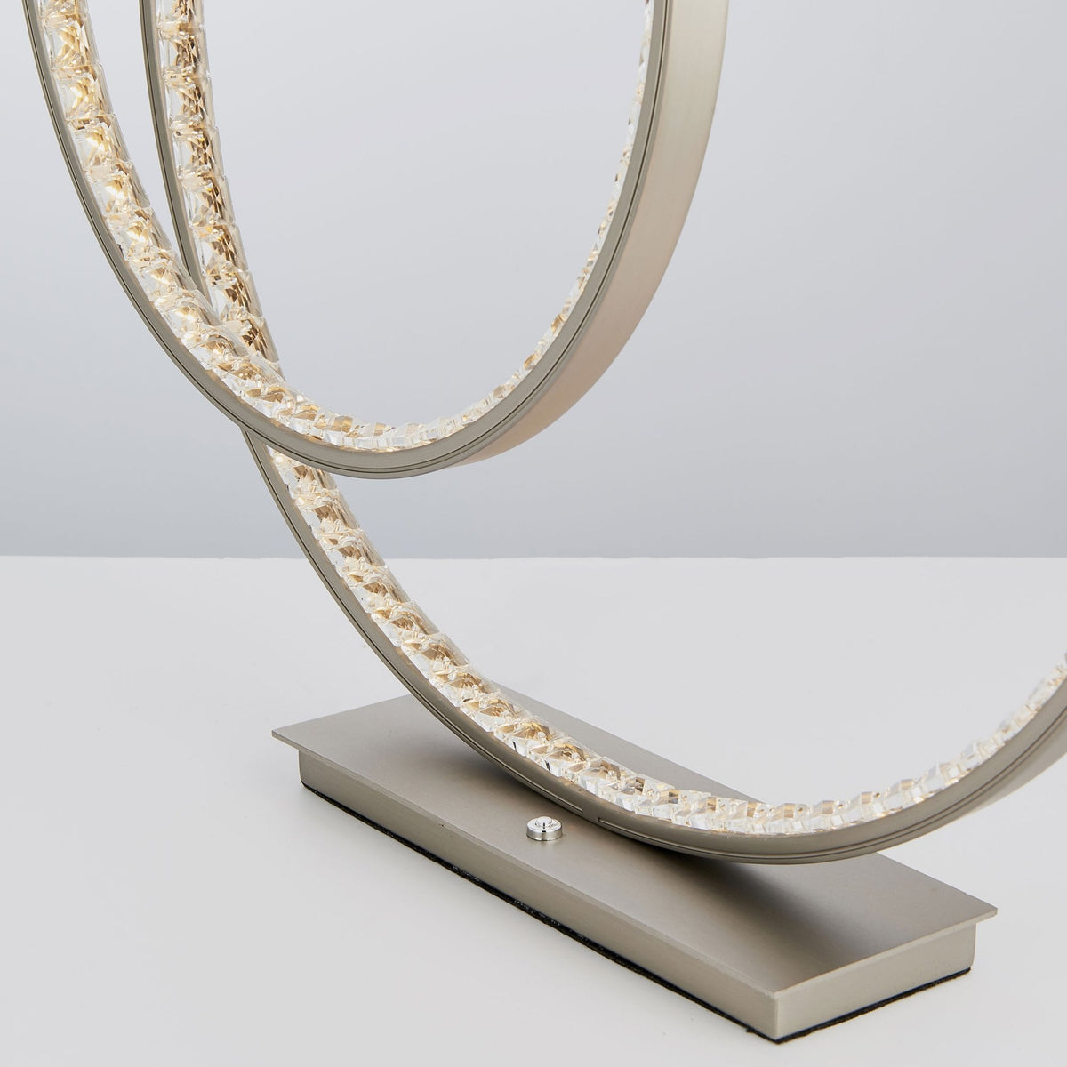 Close-up of the lamp's base and lower illuminated ring, showing crystal details and power button from a different angle.