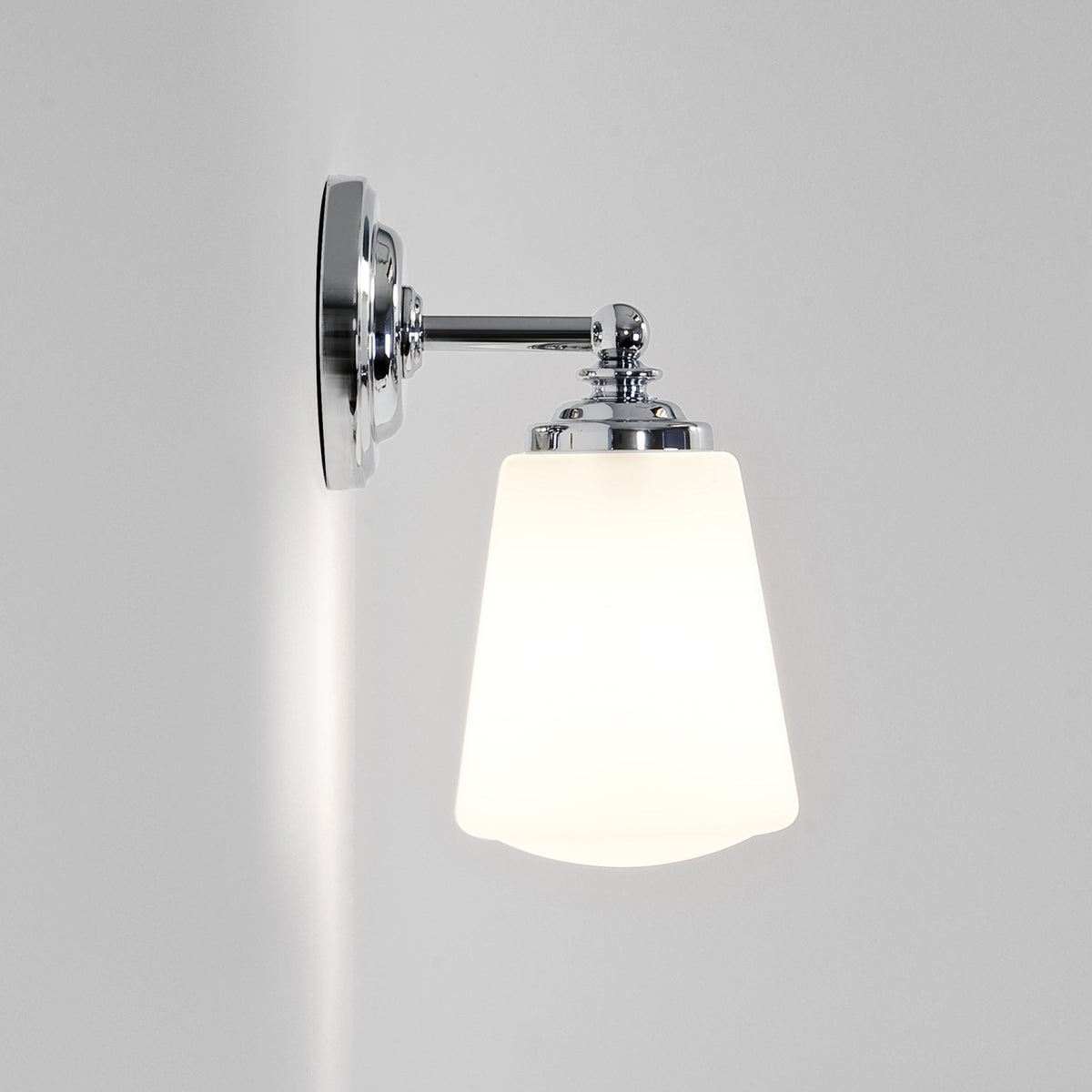 Polished chrome wall light with a white tapered glass shade