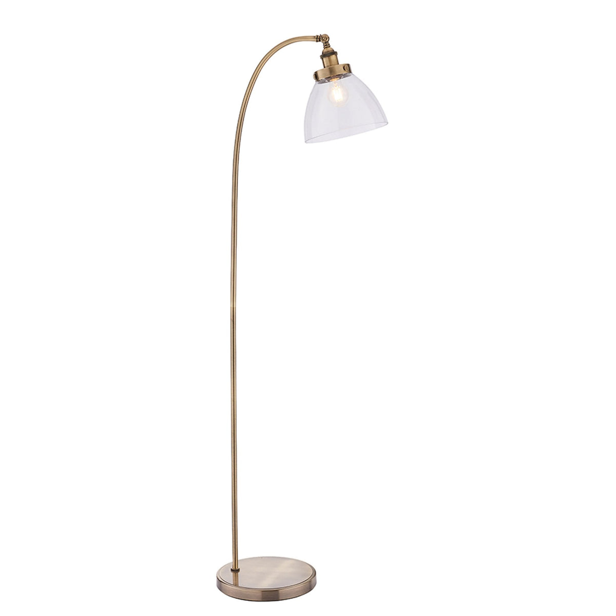 Full view of an antique brass floor lamp with a curved arm and a clear, fluted glass shade on a white background.