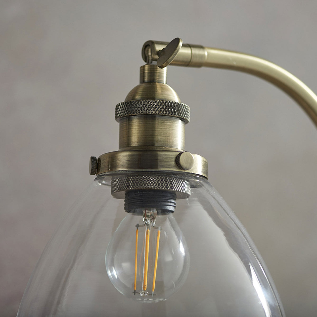 Hansen Task Table Lamp in Antique Brass and Clear Glass Shade