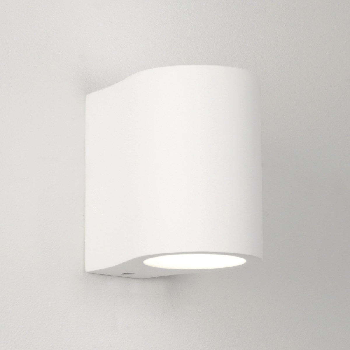 White cylindrical wall light with a curved top and a downward-facing light source