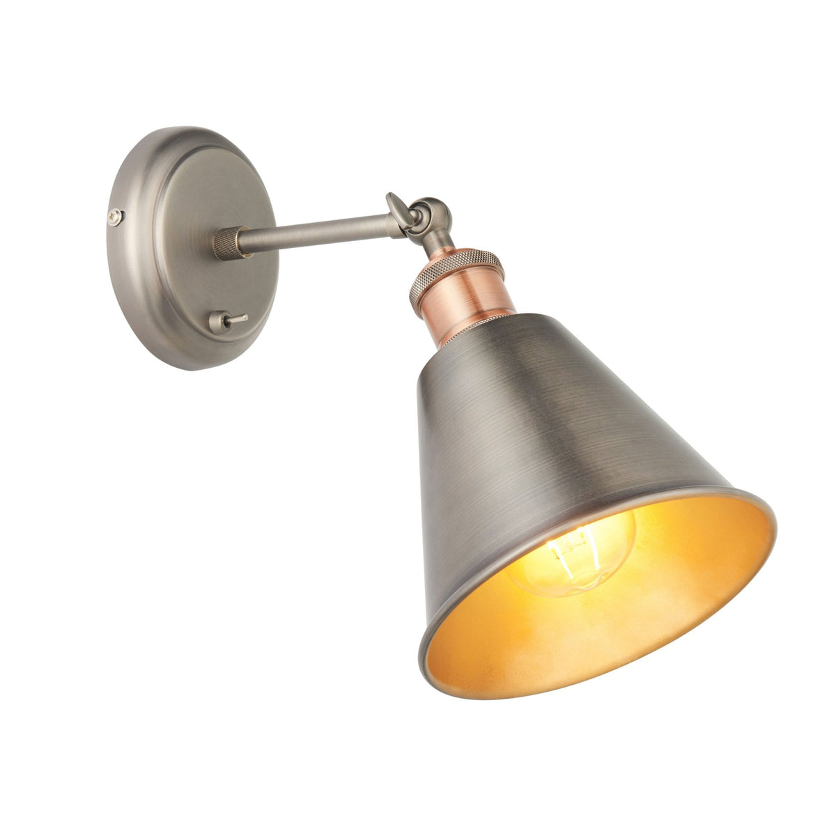 Brushed metal wall light with a conical shade and copper accent, angled downwards with a visible glowing bulb.