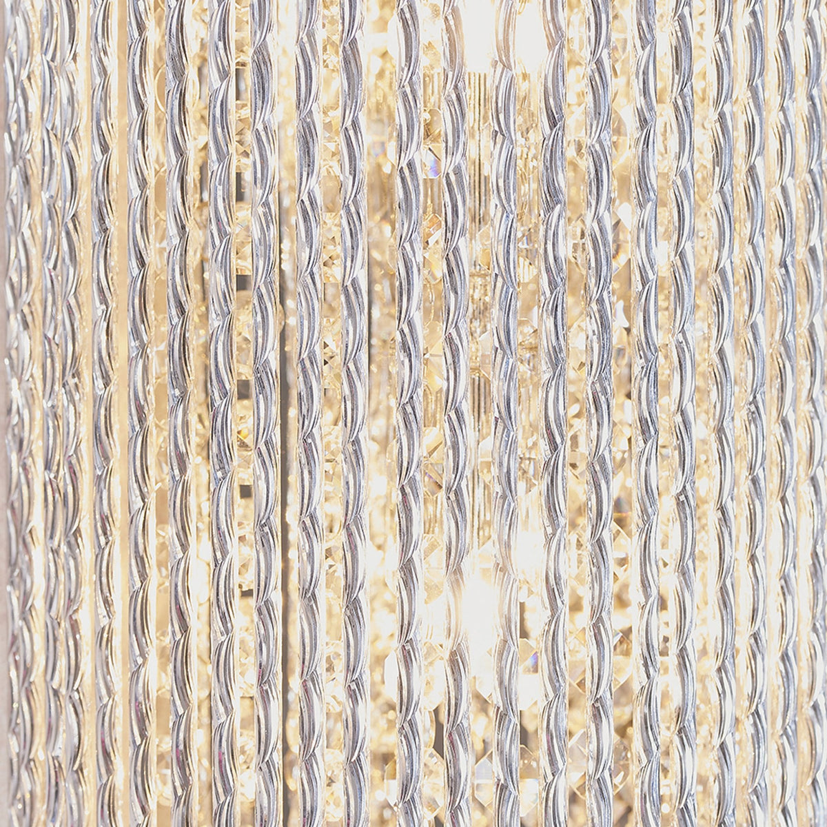 Close-up of the textured clear glass rods of a wall light, showing vertical lines and light reflections.