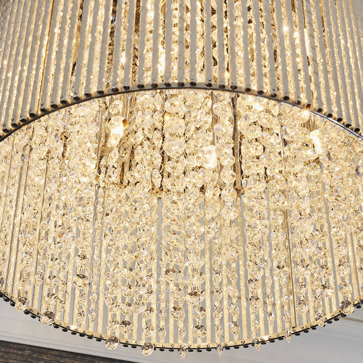 Close-up of the bottom of a round ceiling light, showing rows of sparkling crystal accents.