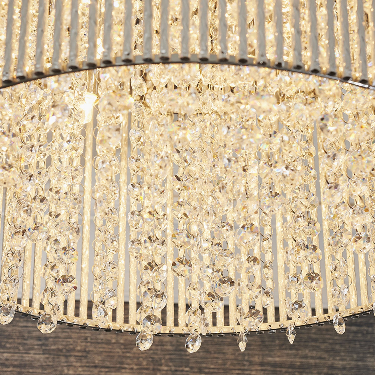 Detailed view of the crystal drops on the bottom of a round ceiling light fixture.